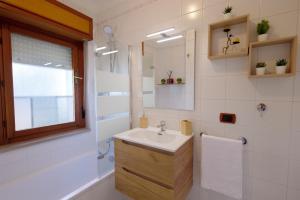 a bathroom with a sink and a mirror at Tree home in Salerno Airport - Aeroporto di Salerno +26 photos