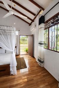 En eller flere senge i et værelse på Nisadi Villa