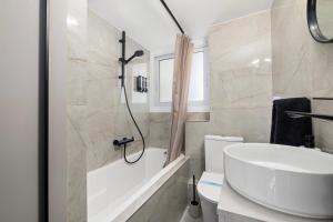 a bathroom with a sink and a tub and a toilet at Mnasiadou Suite 16 in Nicosia +18 photos