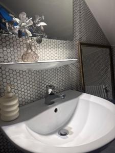 a white sink in a bathroom with a mirror at Übernachten in Stuttgart