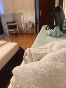 a room with a table with a towel on it at Übernachten in Stuttgart