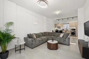a living room with a couch and a table at Mnasiadou Suite 16 in Nicosia