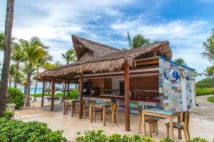 a restaurant on the beach with tables and chairs at Select Club at Sandos Playacar All Inclusive - Adults Only Area in Playa del Carmen