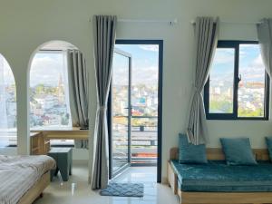 a bedroom with two beds and a large window at LENA Home in Da Lat +161 photos
