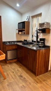 a kitchen with a sink and a counter top at Casa Margarita in Pátzcuaro +15 photos