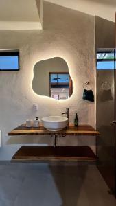a bathroom with a sink and a mirror at Casa Margarita in Pátzcuaro