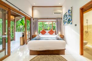 a bedroom with a bed with two teddy bears on it at Bali Dream Garden - Tropical Escape with Pool & Spa in Ubud