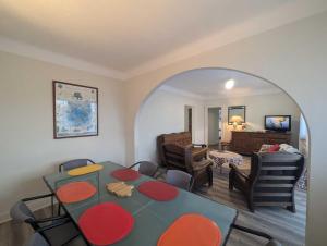 een kamer met een tafel en stoelen en een woonkamer bij Villa jeandor in Braucourt