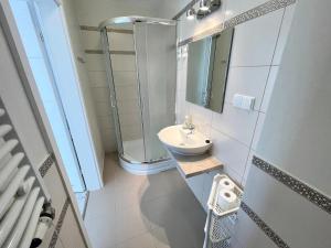 een kleine badkamer met een wastafel en een douche bij pensjonat KAJA 200 metrów od morza in Międzyzdroje +7 foto's