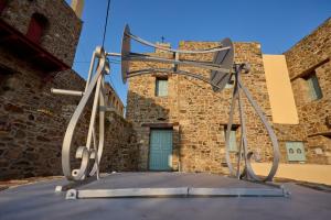 a large metal object on the roof of a building at Volissos Pirgos Village in Volissos +107 photos
