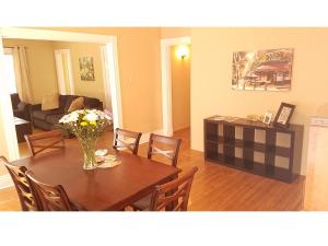 a living room with a table with a vase of flowers at The B in Louisville