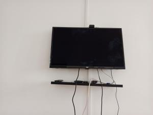 a flat screen tv hanging on a wall at MiMi24 in Mahajanga