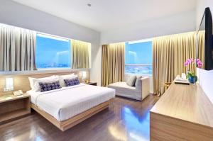 Postel nebo postele na pokoji v ubytování Grand Zuri Malioboro + 53 fotografií