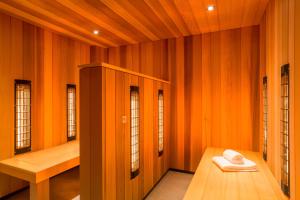 a sauna with orange walls and wooden floors and windows at Hotel2Stay in Amsterdam