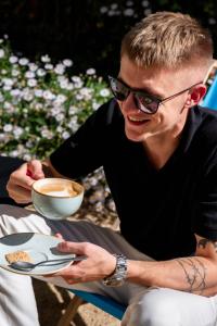 a man sitting at a table with a bowl of food at Cocoon Sendlinger Tor in Munich