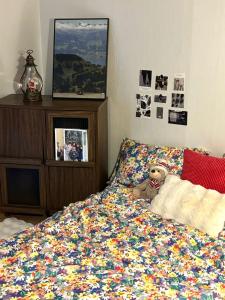 a bed with a teddy bear sitting on top of it at Tage House in Busan +6 photos