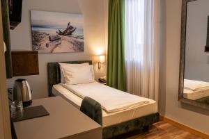 Giường trong phòng chung tại Garni Hotel Mediteraneo