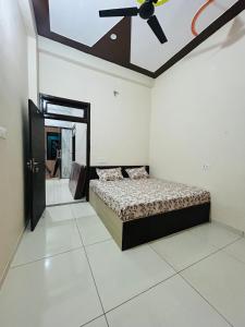 a bedroom with a bed and a ceiling fan at New hotel Arjun place, Reengus in Rīngas