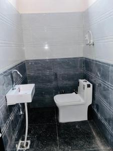 a bathroom with a toilet and a sink at New hotel Arjun place, Reengus in Rīngas