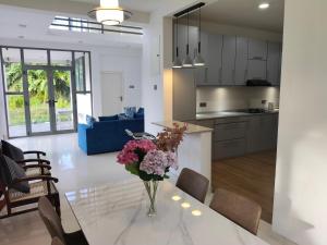 a vase of flowers on a table in a kitchen at Luxe Diamond Villa in Matara