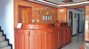 a bar in a room with wood paneling at Mayon Backpackers Hostel in Bariw
