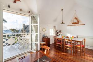 a dining room with a table and a view of the ocean at Le Nautic - 5min à pied de la plage in Bénodet