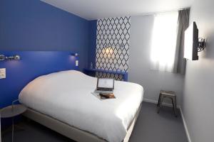 Een bed of bedden in een kamer bij Coto Hotel