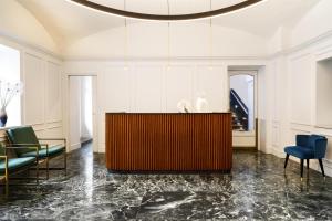 a living room with a table and chairs at Best Western Plus Royal Superga Hotel in Cuneo