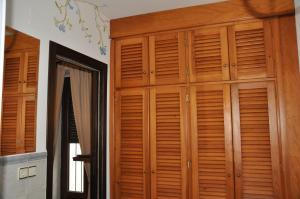 a room with wooden cabinets and a mirror at Casa de las Remigias in Estepona