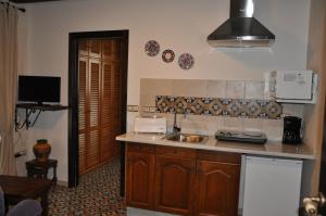 a kitchen with a sink and a counter top at Casa de las Remigias in Estepona