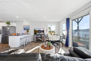 a kitchen and living room with a couch and a table at Waterfront Walk Out with Private Terrace in Groton