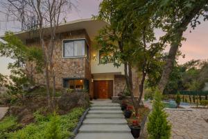 a house with a pathway leading to the front door at SaffronStays Grand Pavilion in Udaipur