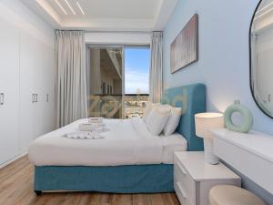 a bedroom with a bed and a large window at ZAPBED HOUSE -1 BR In Pacific Tower Al Marjan Island With Beach Access Ras Al Khaimah in Ras al Khaimah +24 photos