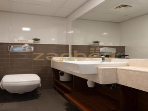 a bathroom with a sink and a toilet at ZAPBED HOUSE -1 BR In Pacific Tower Al Marjan Island With Beach Access Ras Al Khaimah in Ras al Khaimah
