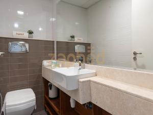 a bathroom with a sink and a toilet at ZAPBED HOUSE -1 BR In Pacific Tower Al Marjan Island With Beach Access Ras Al Khaimah in Ras al Khaimah +45 photos