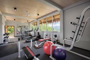 a gym with several treadmills and exercise machines at 98 Acres Resort & Spa in Ella