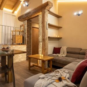 a living room with a couch and a table at Paradiso di Grosio - mansarda con vista montagne in Grosio