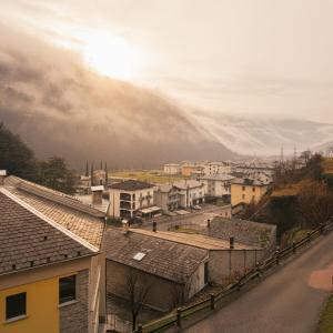 a view of a city with houses and buildings at Paradiso di Grosio - mansarda con vista montagne in Grosio