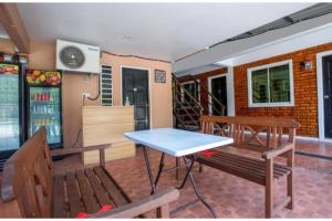 ein Esszimmer mit 2 Bänken und einem Tisch in der Unterkunft Hotel O Classic Homestay Keningau in Keningau