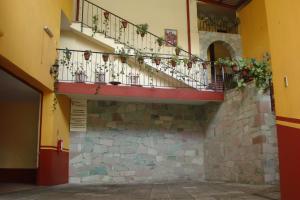 a building with a balcony with plants on it at Hotel Camino de Villaseca in Guanajuato