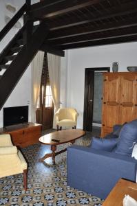 a living room with a blue couch and a table at Casa de las Remigias in Estepona