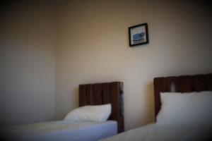 a bedroom with two beds and two lamps at Hostel Gosti Krasnodar in Pashkovskiy