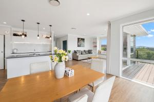 a kitchen and living room with a table and chairs at A million city views in Rotorua