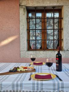 een tafel met twee glazen en een fles wijn bij Kraska hisa in Komen