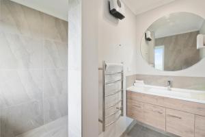 a bathroom with a sink and a mirror at A million city views in Rotorua +18 photos