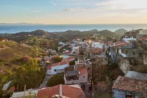 a view of a town with the ocean in the background at Volissos Pirgos Village in Volissos