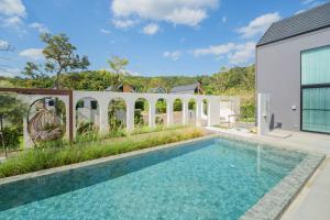 a swimming pool in the backyard of a house at HighView PoolVilla at Khaoyai in Ban Bung Toei