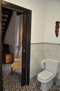 a bathroom with a white toilet and a stairway at Casa de las Remigias in Estepona
