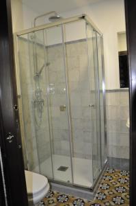 a bathroom with a glass shower with a toilet at Casa de las Remigias in Estepona