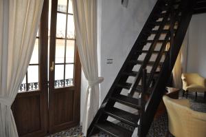 a wooden staircase leading to a room with a door at Casa de las Remigias in Estepona